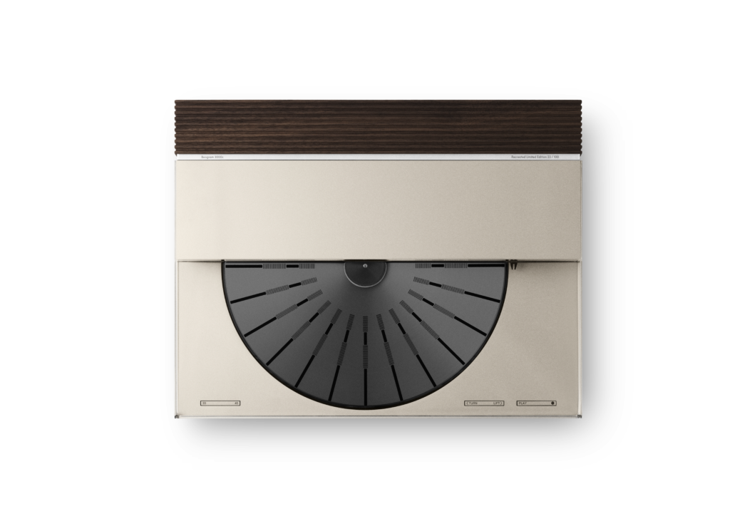 Close-up of a beige Beosystem 3000c with a dark wood vent above and a large circular gray dial with black radial markings.