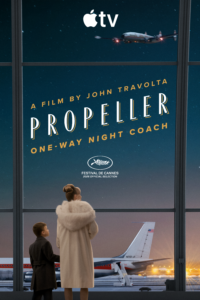 Poster advertising a film titled Propeller by John Travolta, shown inside a window with an airplane,夜-blue sky, and Cannes festival branding; foreground shows two people viewing from outside.