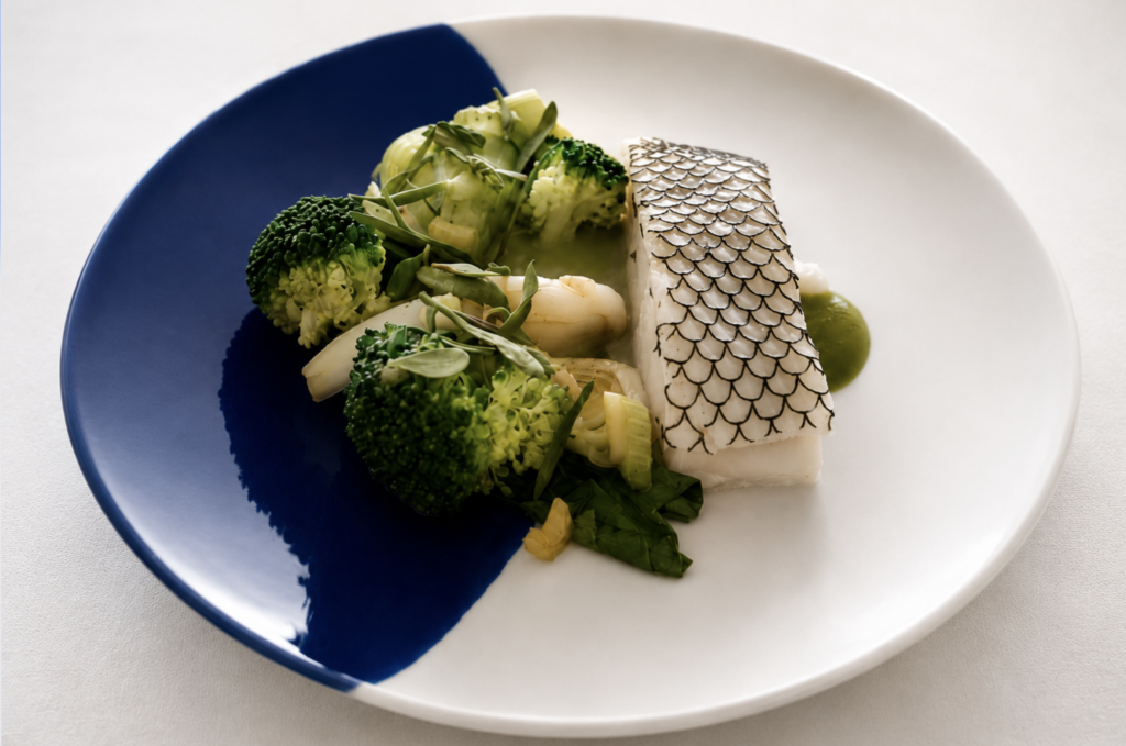 Poisson à la peau nacrée, légumes verts et herbes fraîches composent une assiette lumineuse où la précision du geste laisse toute sa place au produit. Une interprétation sensible du territoire imaginée par le chef Ronan Fillatre au George's.